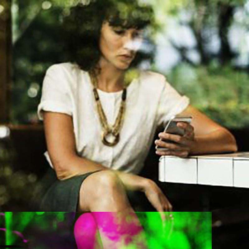 Businesswoman using mobile phone in coffee shop