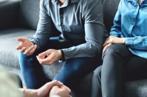 Legal mediator sitting with clients on couch