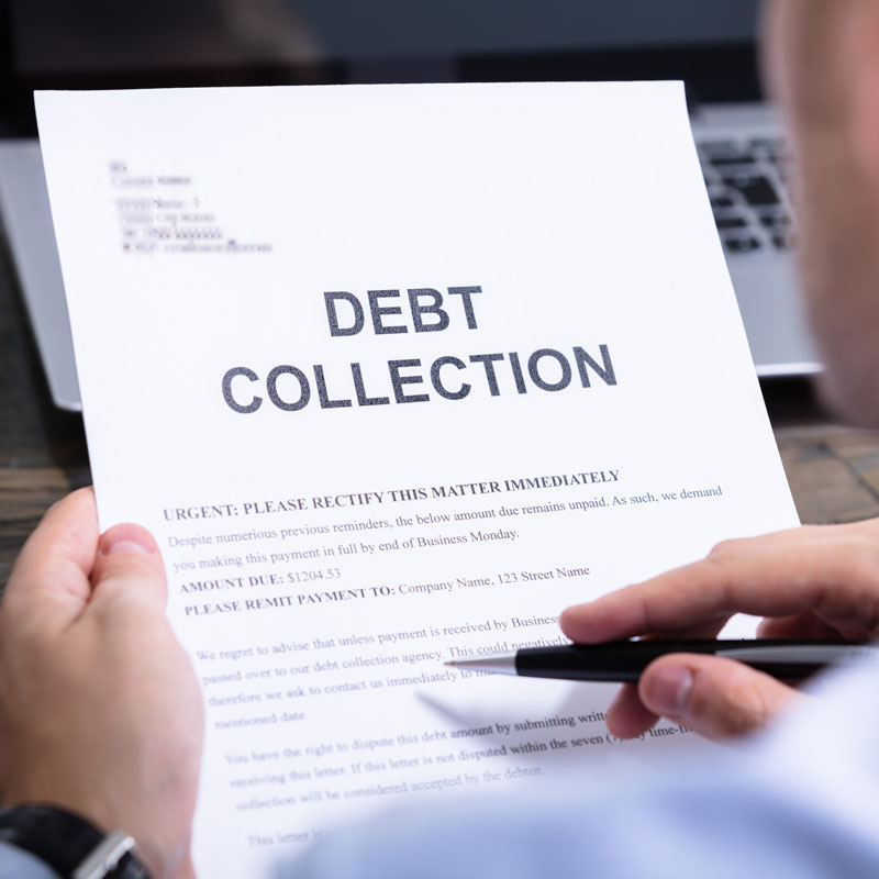 Man Reading Debt Collection Form with Pen Poised