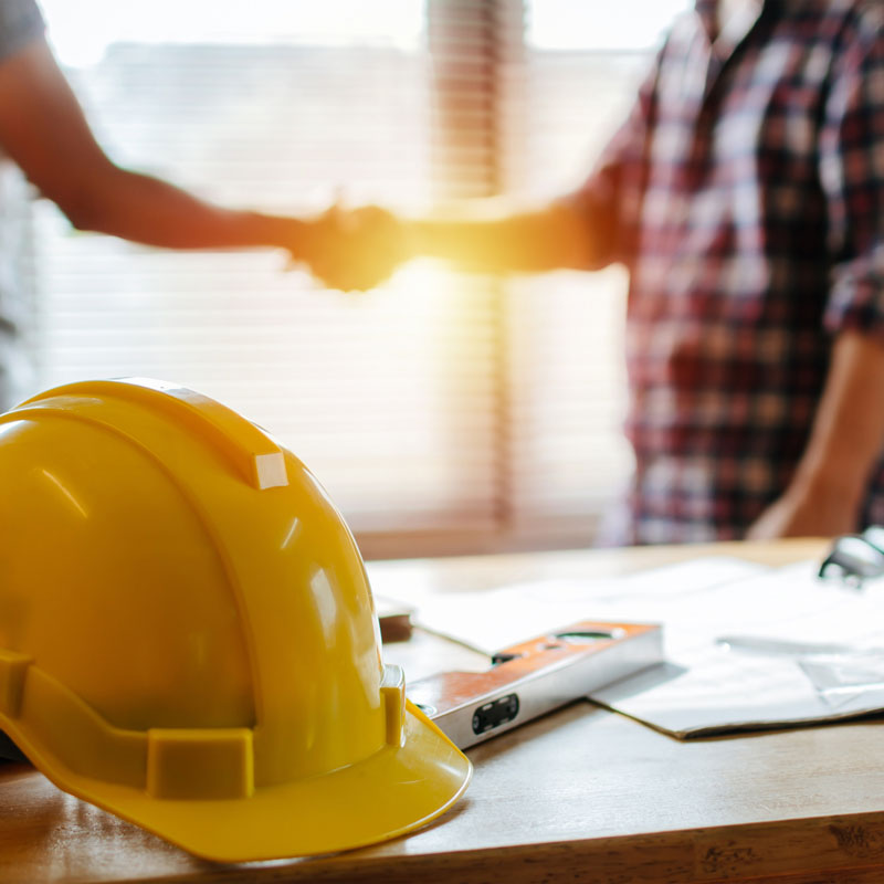 Construction Worker Shaking Hands with Litigation Attorney