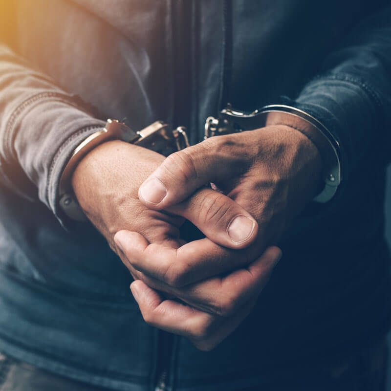 Close-up of handcuffed man’s hands
