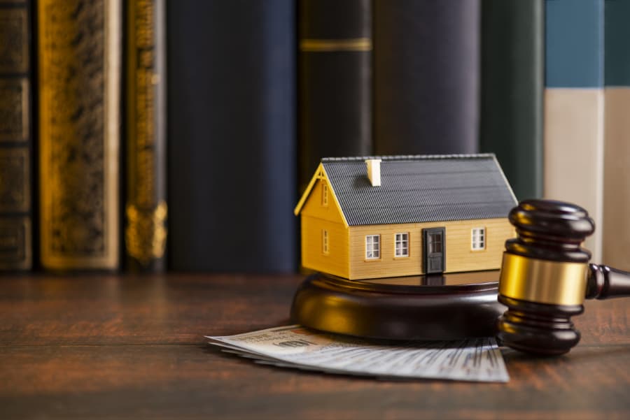 Model house sitting on gavel in attorney office