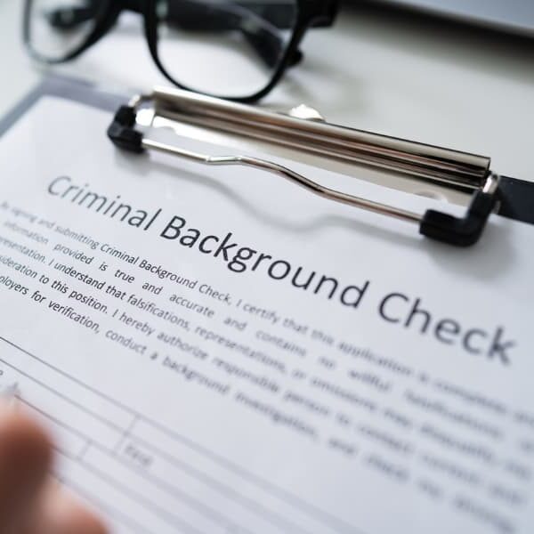 A person filling out a criminal background check request form