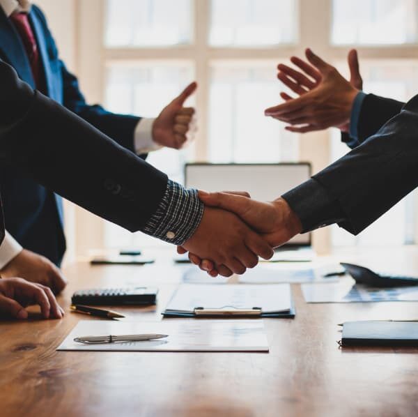 Businessmen shaking hands after coming to an agreement