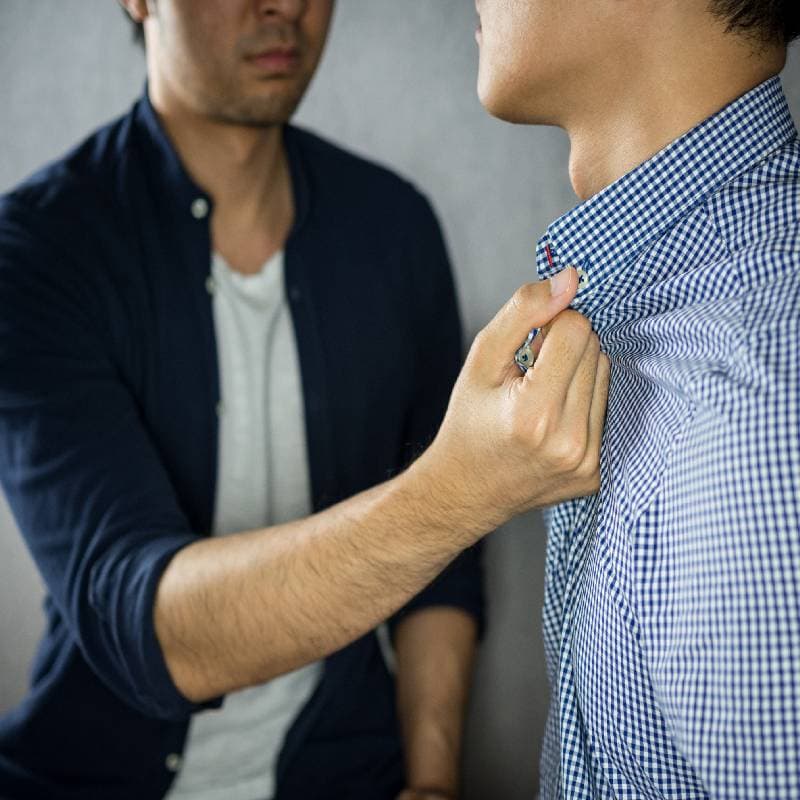 Man grabbing another man by the collar