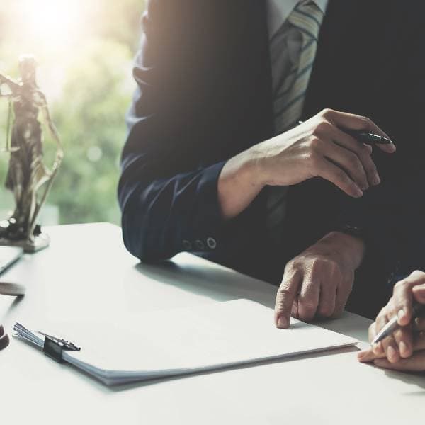 Two people looking at a legal document