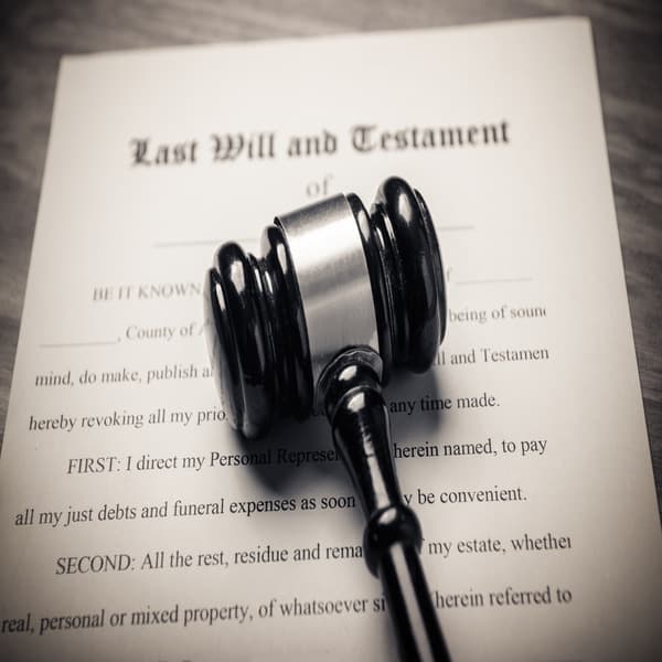 Last will and testament document with a gavel on top